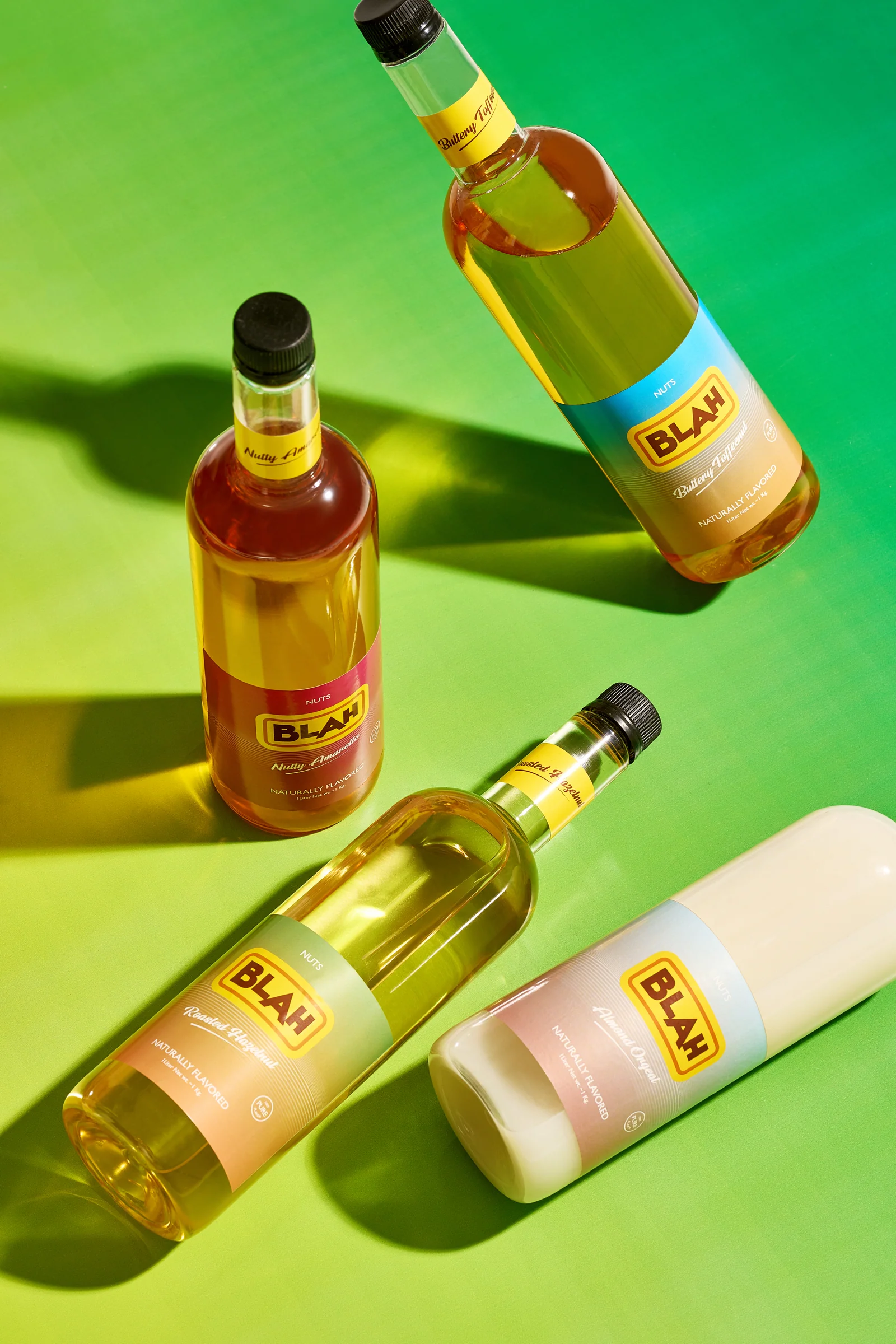 Four Blah nut syrups on a bright green gradient